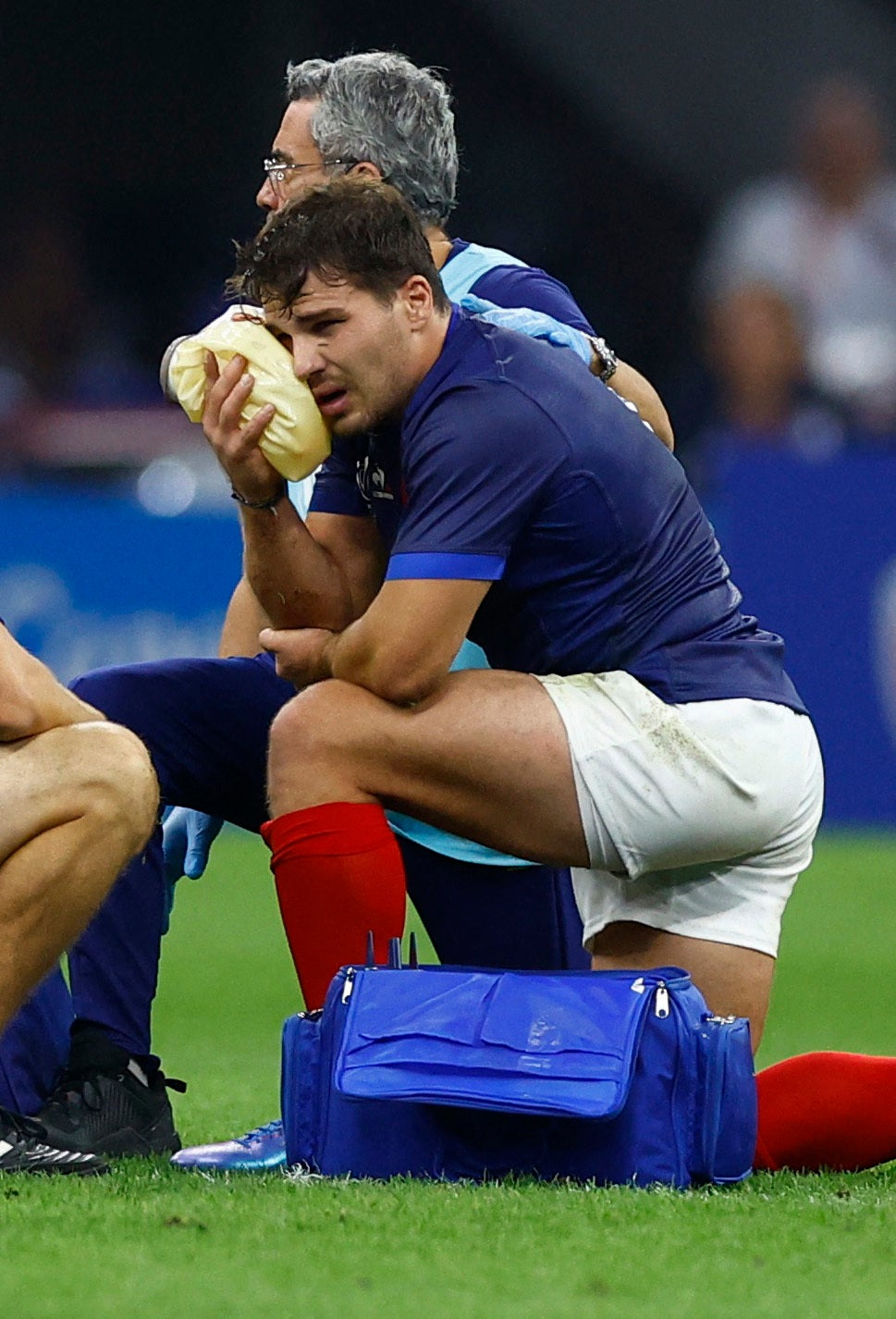 France’s Antoine Dupont receives treatment after taking a knock to the head