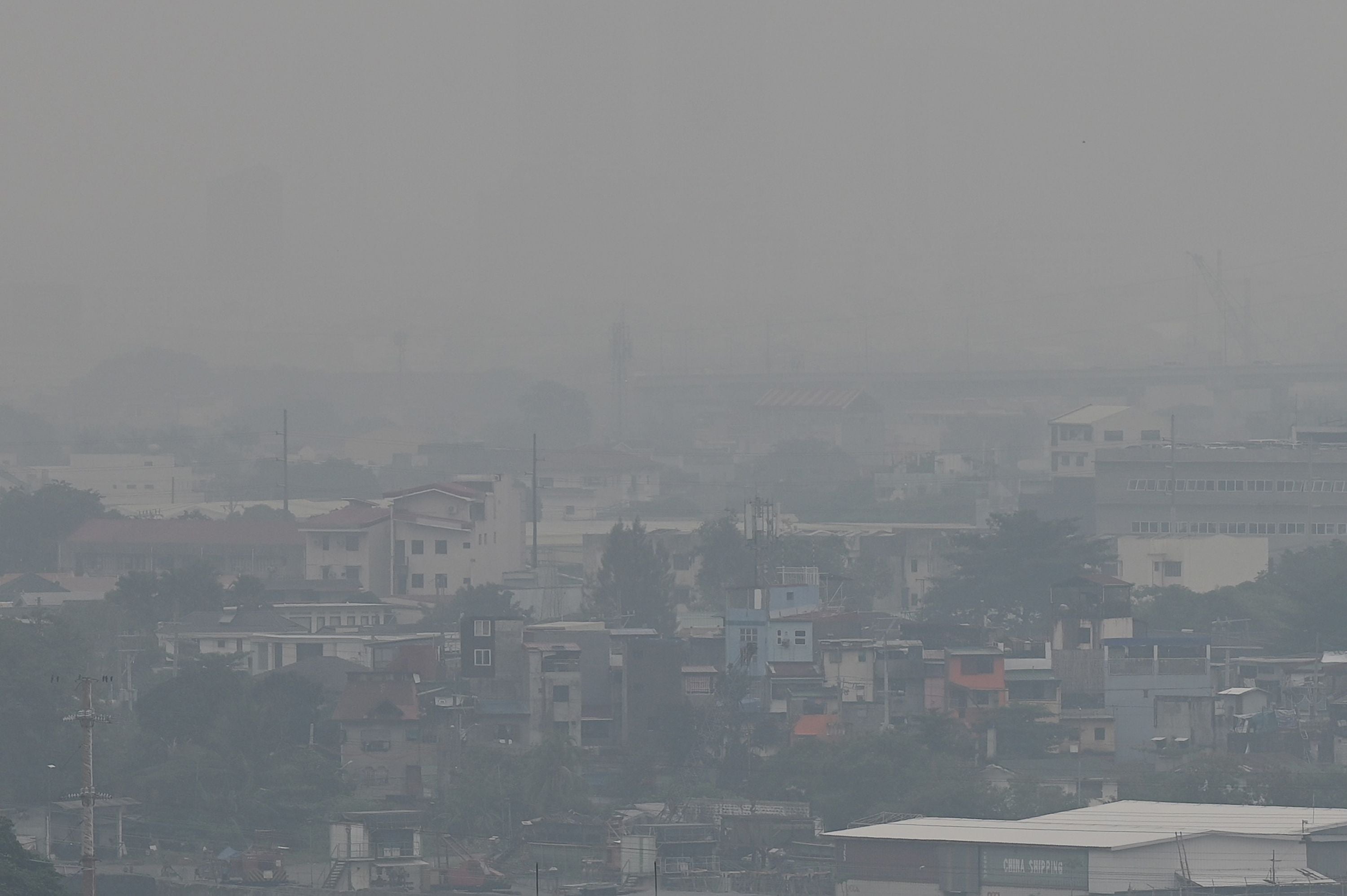 <p>The Manila skyline is seen shrouded in smog</p>