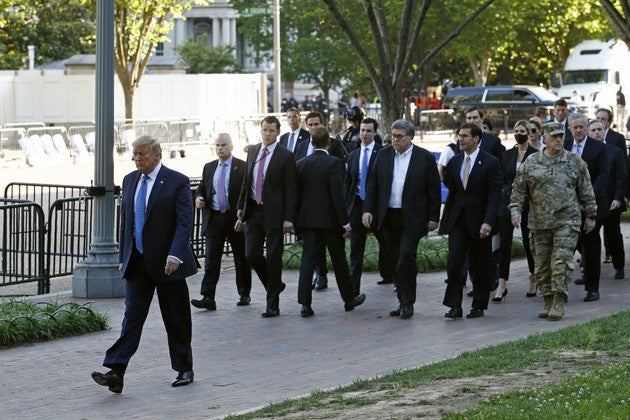 President Donald Trump walks in Lafayette Park to visit outside St. John’s Church across from the White House on June 1, 2020. Mark Milley is seen wearing his military uniform in the picture