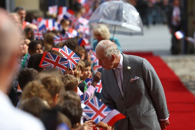 The King speaks to members of the public gathered in Bordeaux (Hannah McKay/PA)