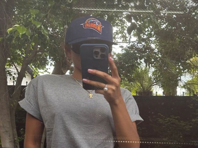 Zendaya shares selfie in a car reflection with a Golden State Warriors hat and ring on her finger