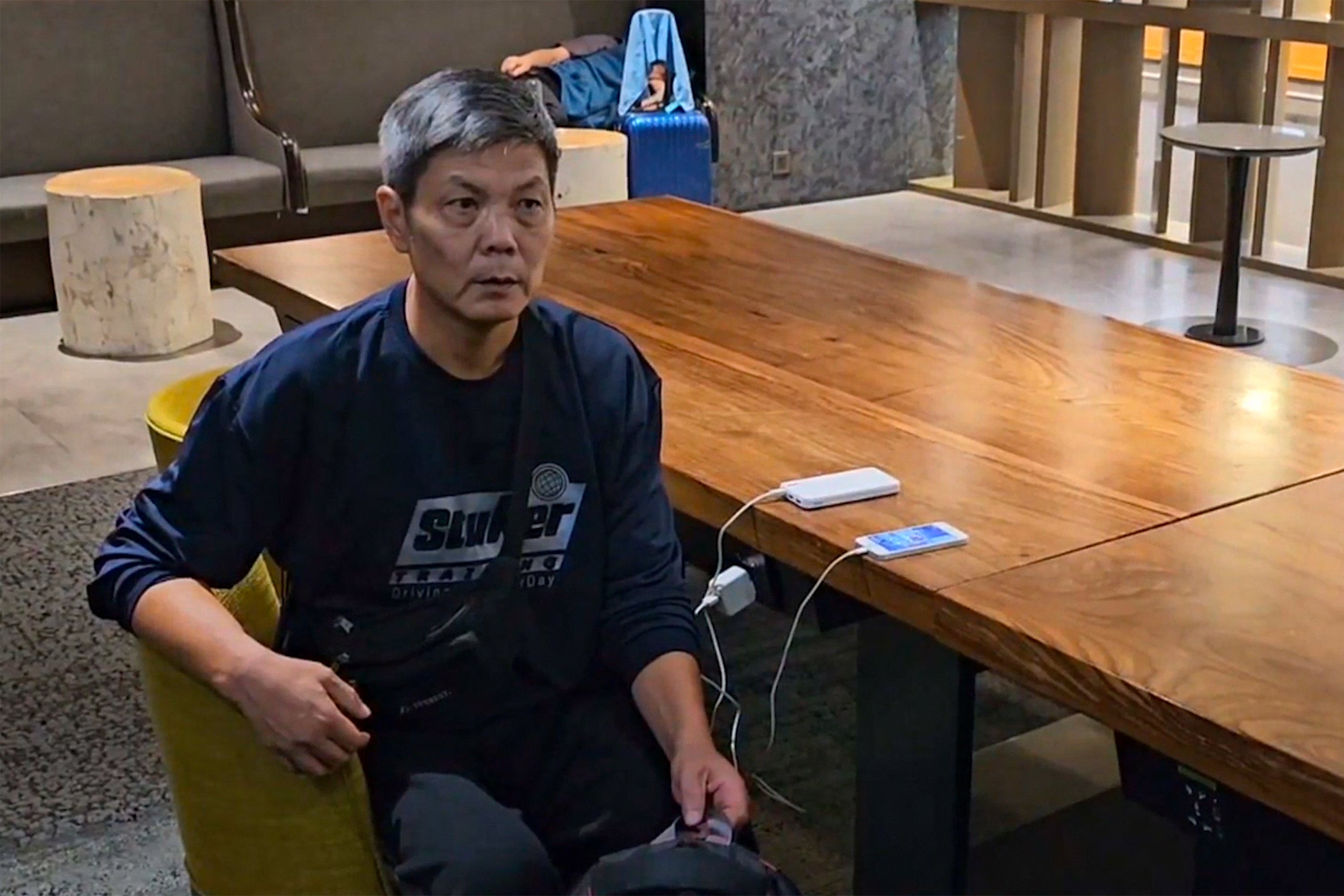 In this image taken from video footage run by TVBS, Chinese dissident Chen Siming can be seen at Taoyuan International Airport’s transit lounge in Taipei, Friday, 22 September 2023