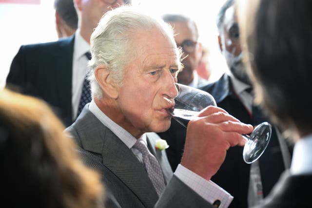 Charles drinking a glass of red wine during his trip to Bordeaux (Daniel Leal/PA)