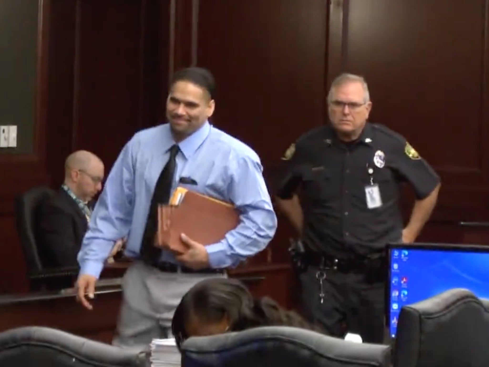Johnathan Quiles, 38, smiles as he enters court, where he was charged with the first-degree murder of his niece, Iyana Sawyer, 16, who was pregnant with his child