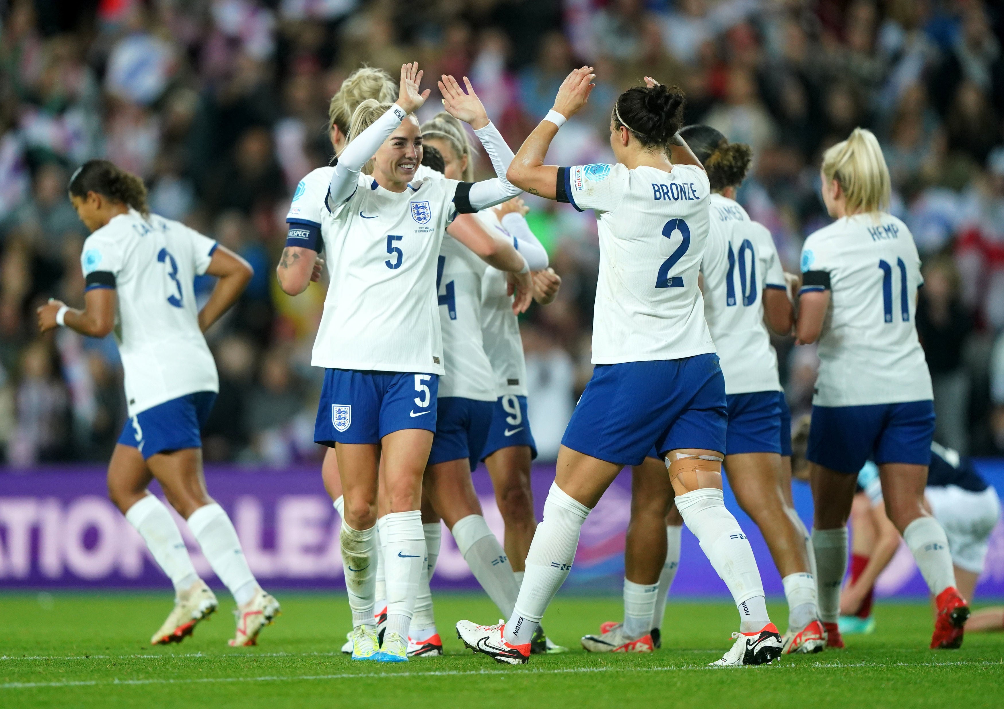 <p> Lucy Bronze, centre right, celebrates scoring England’s first goal of the game on Friday night </p>
