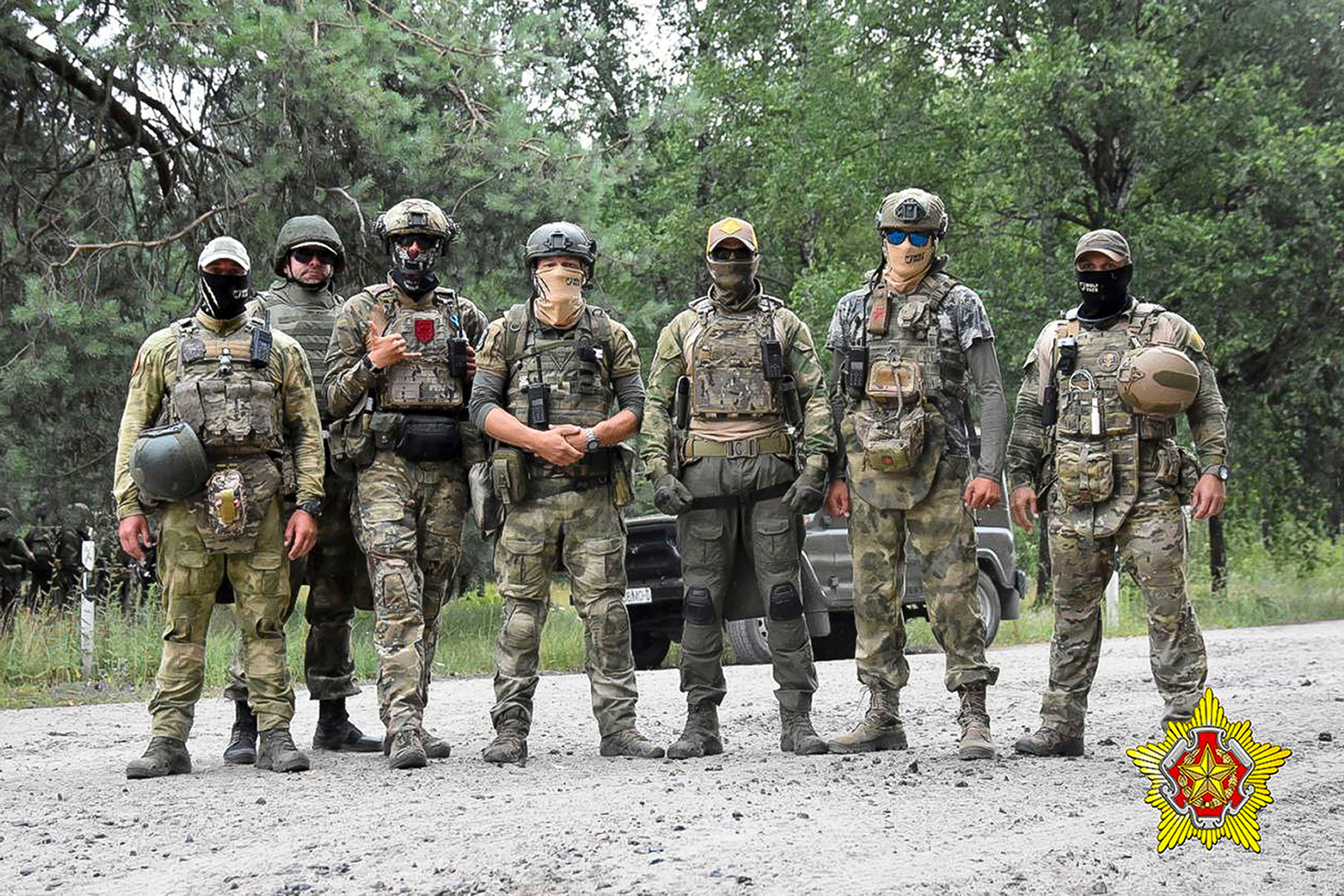 In this photo released by the Belarusian Defense Ministry on Thursday, July 20, 2023, soldiers of the Special Operations Forces (SOF) and mercenary fighters from Wagner private military company pose for a photo while the weeklong maneuvers that will be conducted at a firing range near the border city of Brest, Belarus