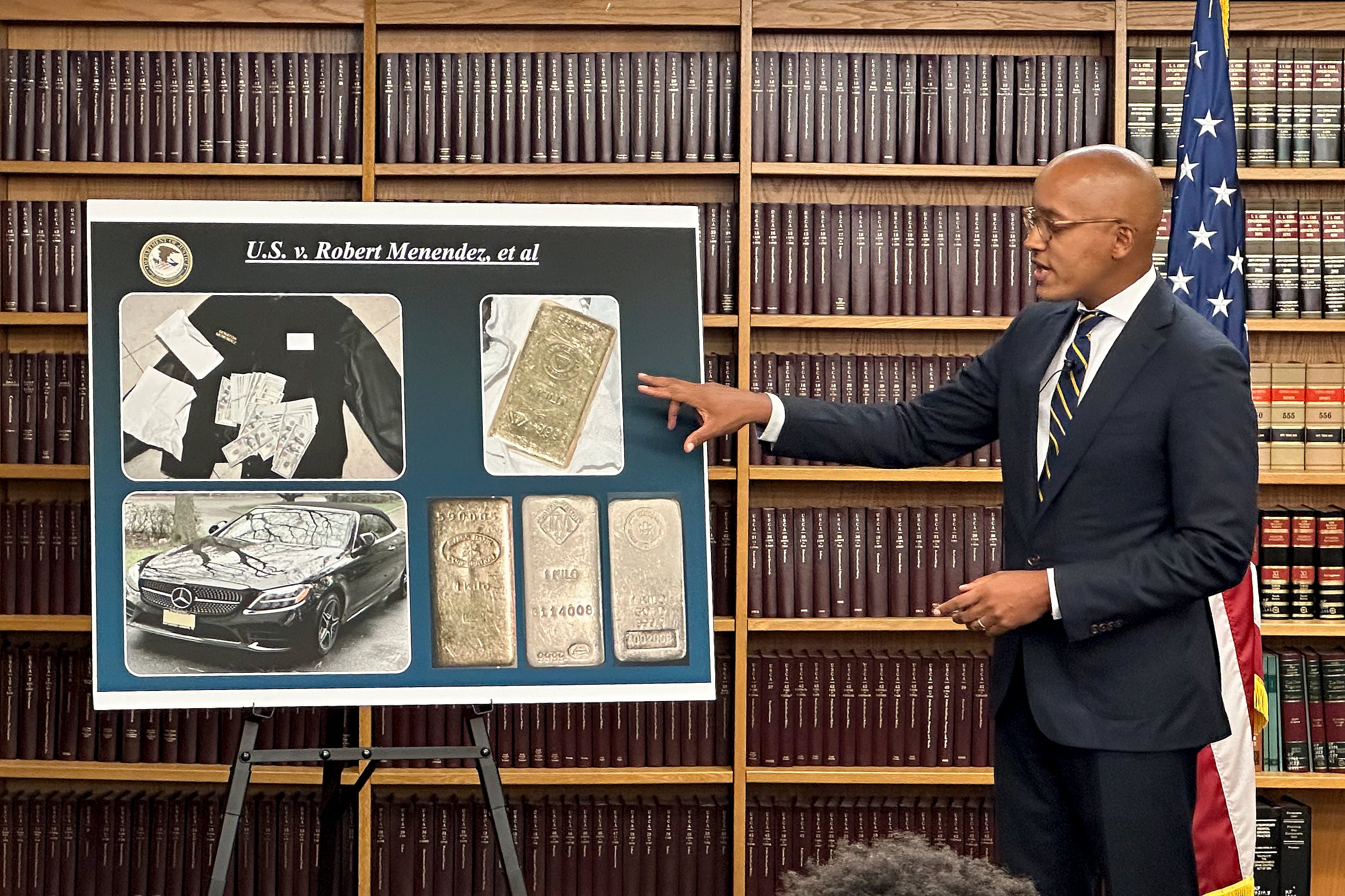 Damian Williams, US Attorney for the Southern District of New York, explains a display of photos of evidence in an indictment against Senator Bob Menendez