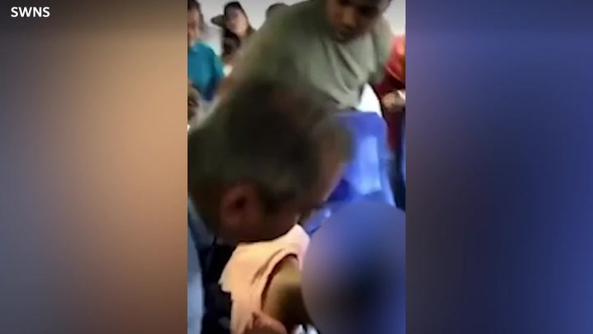 Moment passenger detained and pulled off plane after claims he tried to open emergency door