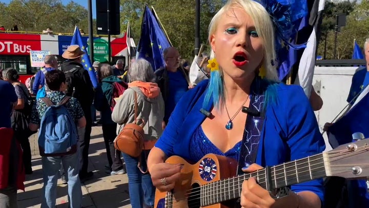 <p>Pro-European Union protester dressed in blue entertains large crowds at London rally with a song.</p>
