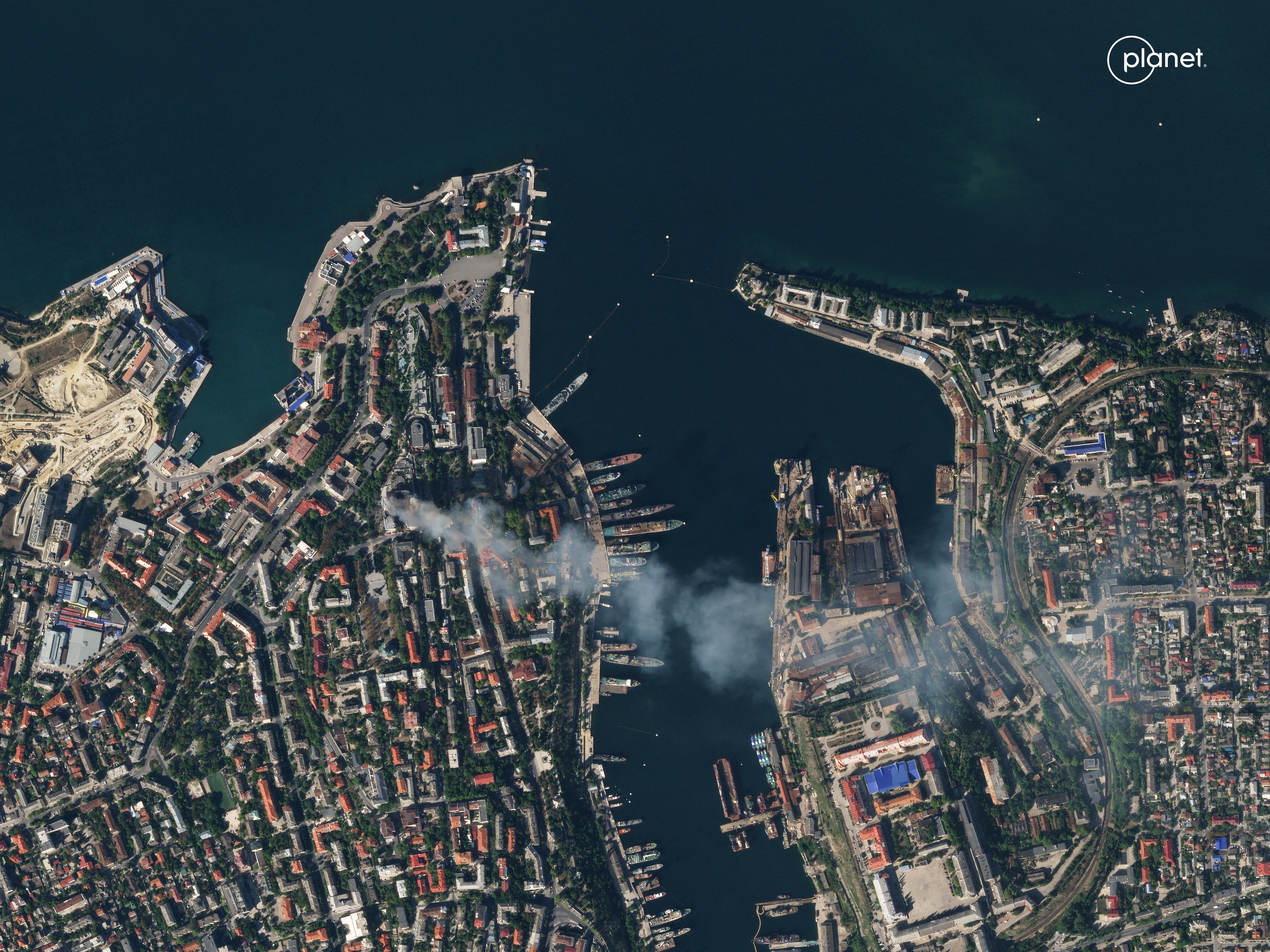 A satellite image shows smoke billowing from the Russian Black Sea navy HQ after a missile strike in Sevastopol