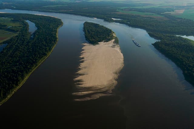 <p>FILE - This aerial photo shows shows a tugboat with barges navigating around a sandbar during a period of low water level in the Mississippi River near the Louisiana State Penitentiary in West Feliciana Parish, Louisiana on Friday, July 21, 2023</p>