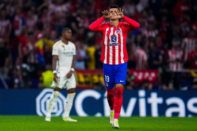 Alvaro Morata celebrates after heading Atletico into a 3-1 lead against derby rivals Real Madrid (Manu Fernandez/AP)