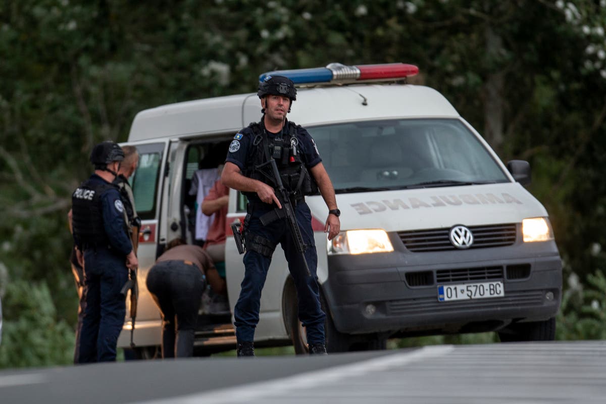 Kosovo mourns a slain police officer, some Serb gunmen remain at large after a siege at a monastery