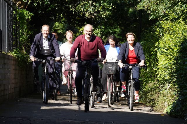 Lib Dem leader Sir Ed Davey alongside West Country MPs and key candidates as they arrive by bicycle for the Liberal Democrat conference at the Bournemouth Conference Centre (Stefan Rousseau/PA)