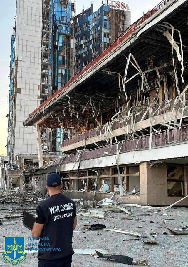 <p>A member of Odesa Regional Prosecutor's Office personnel inspects damage following a Russian military attack,</p>