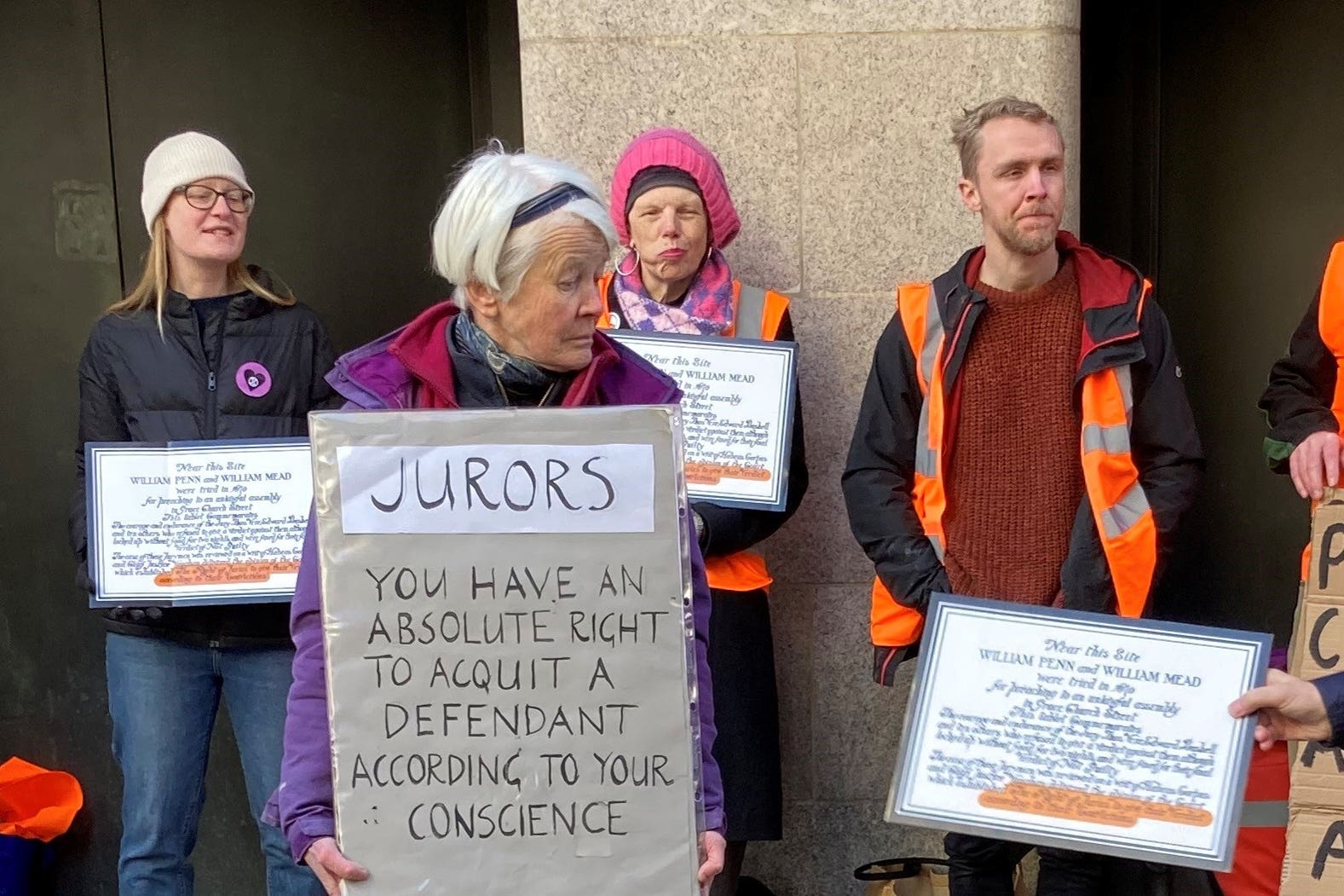 Trudi Warner, a 69-year-old climate change activist, is facing legal proceedings for allegedly holding up a sign in front of jurors