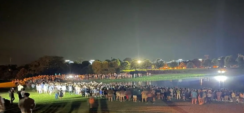 The mass baptism was held around a lake after the Unite Auburn worshipping event