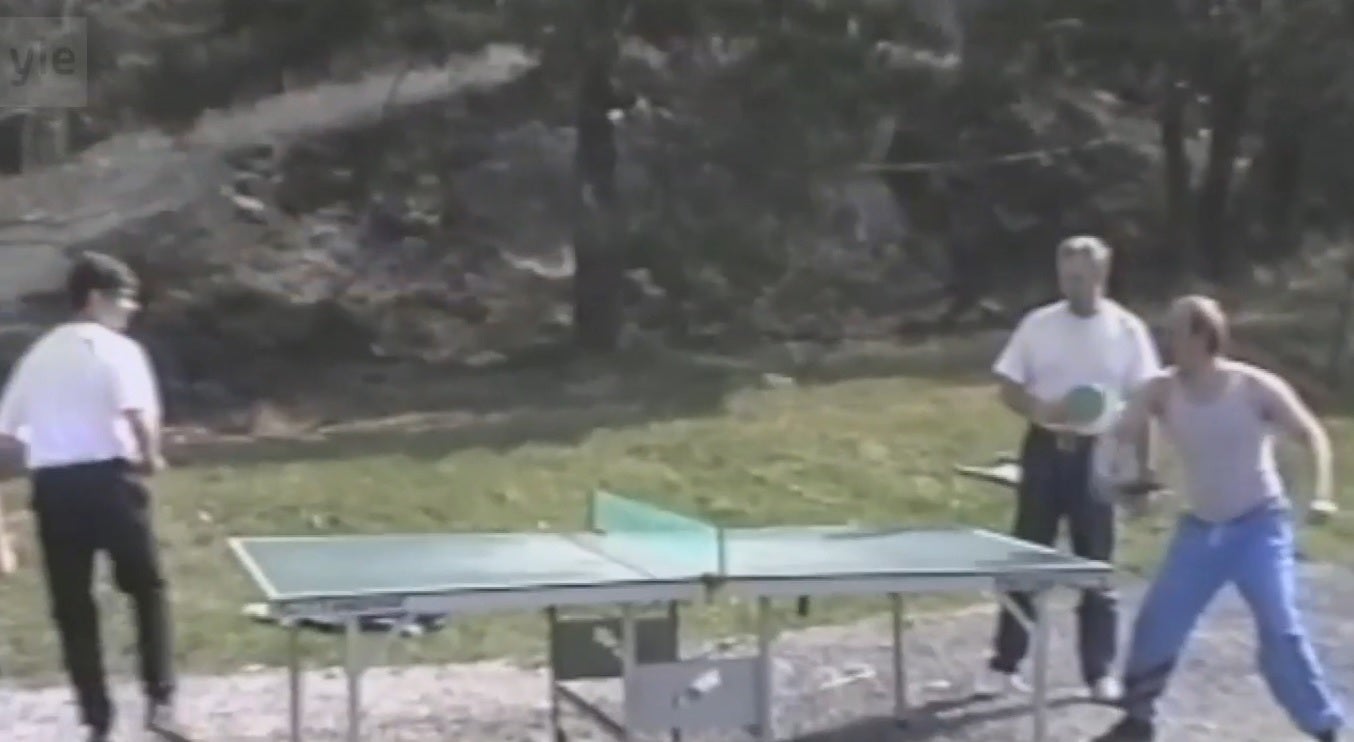 Putin (right) plays ping pong with other guests