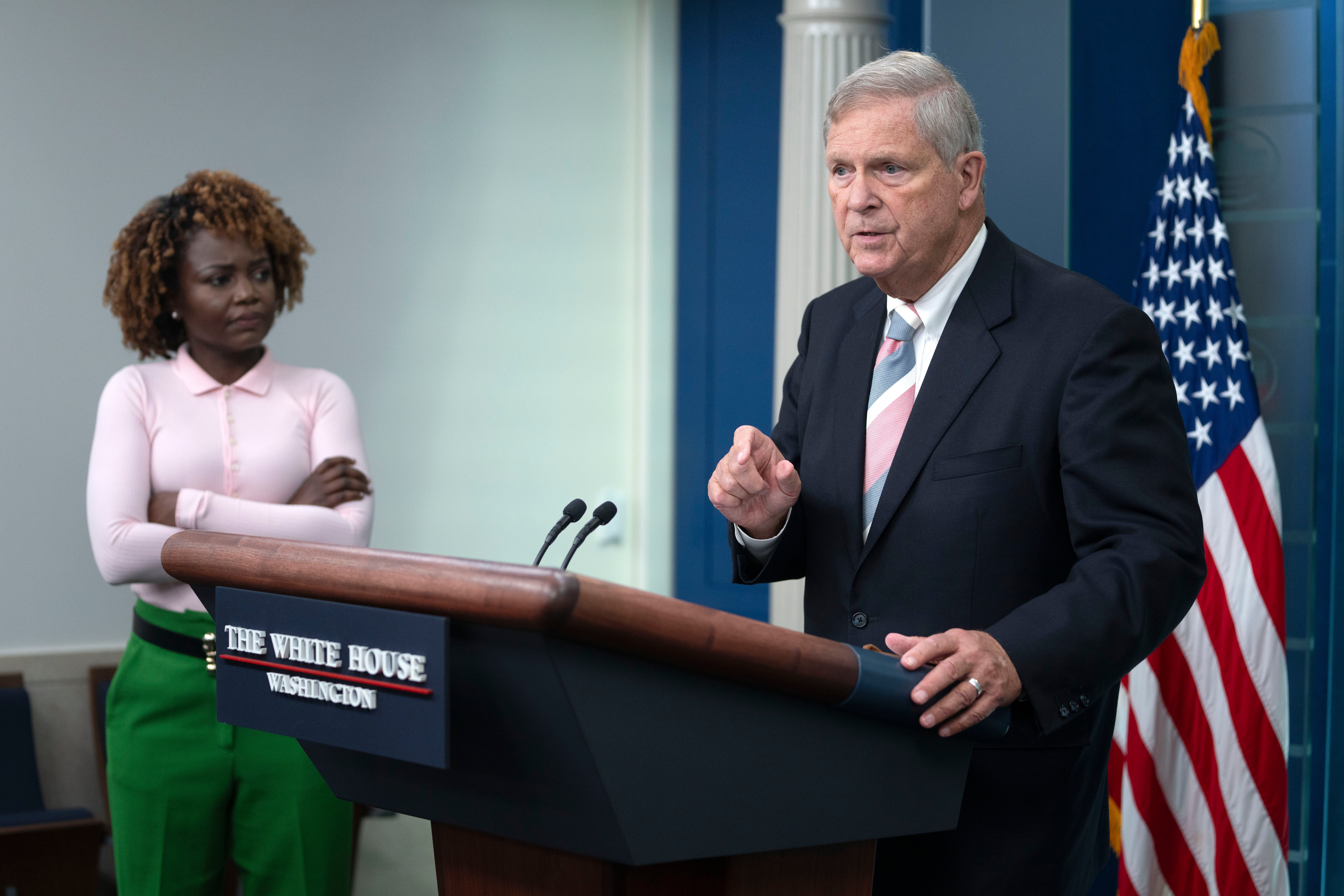 Agriculture Secretary Tom Vilsack speaks during a press briefing at the White House as White House press secretary Karine Jean-Pierre looks on
