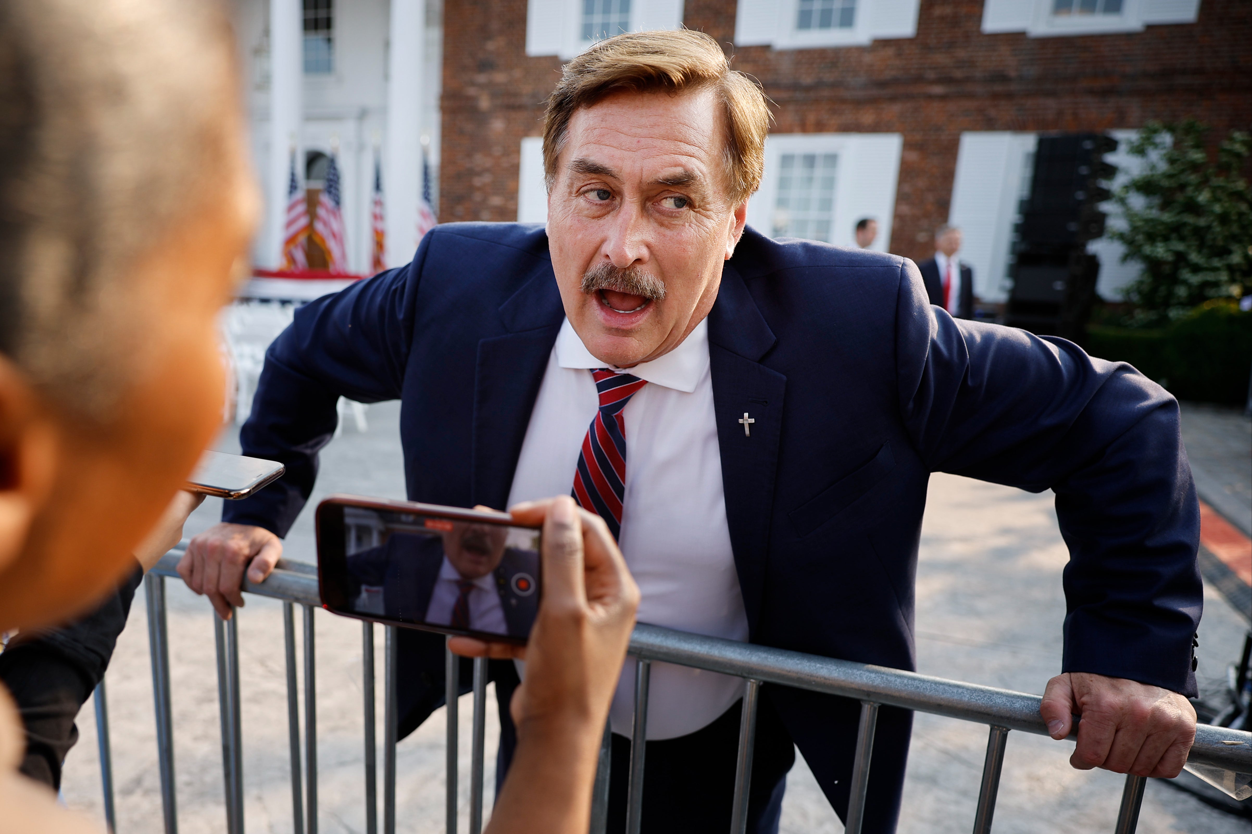 Businessman and election conspiracy theorist Mike Lindell talks with reporters outside the club house at the Trump National Golf Club on 13 June 2023