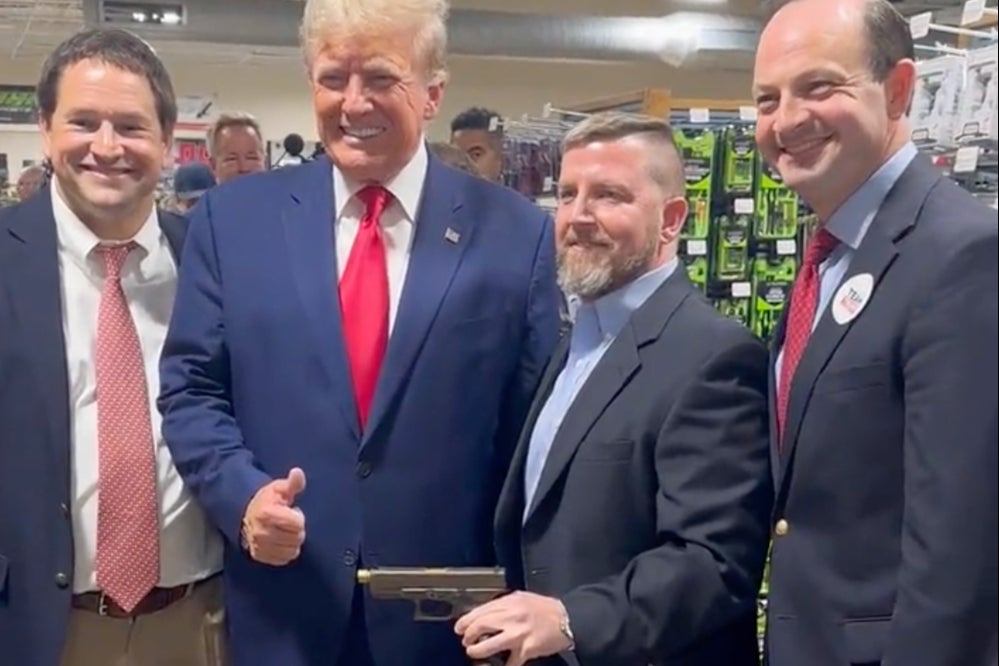 Donald Trump poses with South Carolina Attorney General Alan Wilson, right, at a gun store in South Carolina on 25 September.