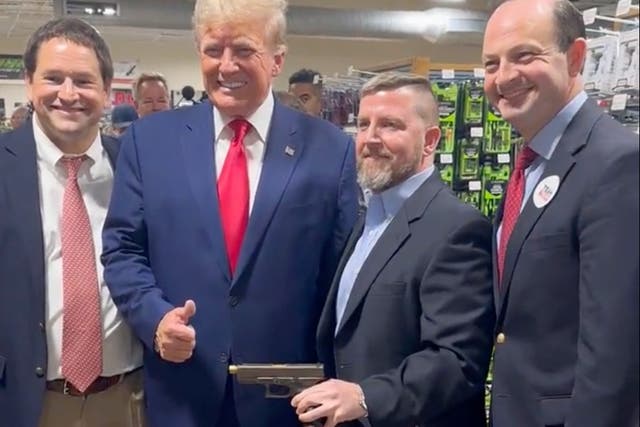 <p>Donald Trump poses with South Carolina Attorney General Alan Wilson, right, at a gun store in South Carolina on 25 September.</p>