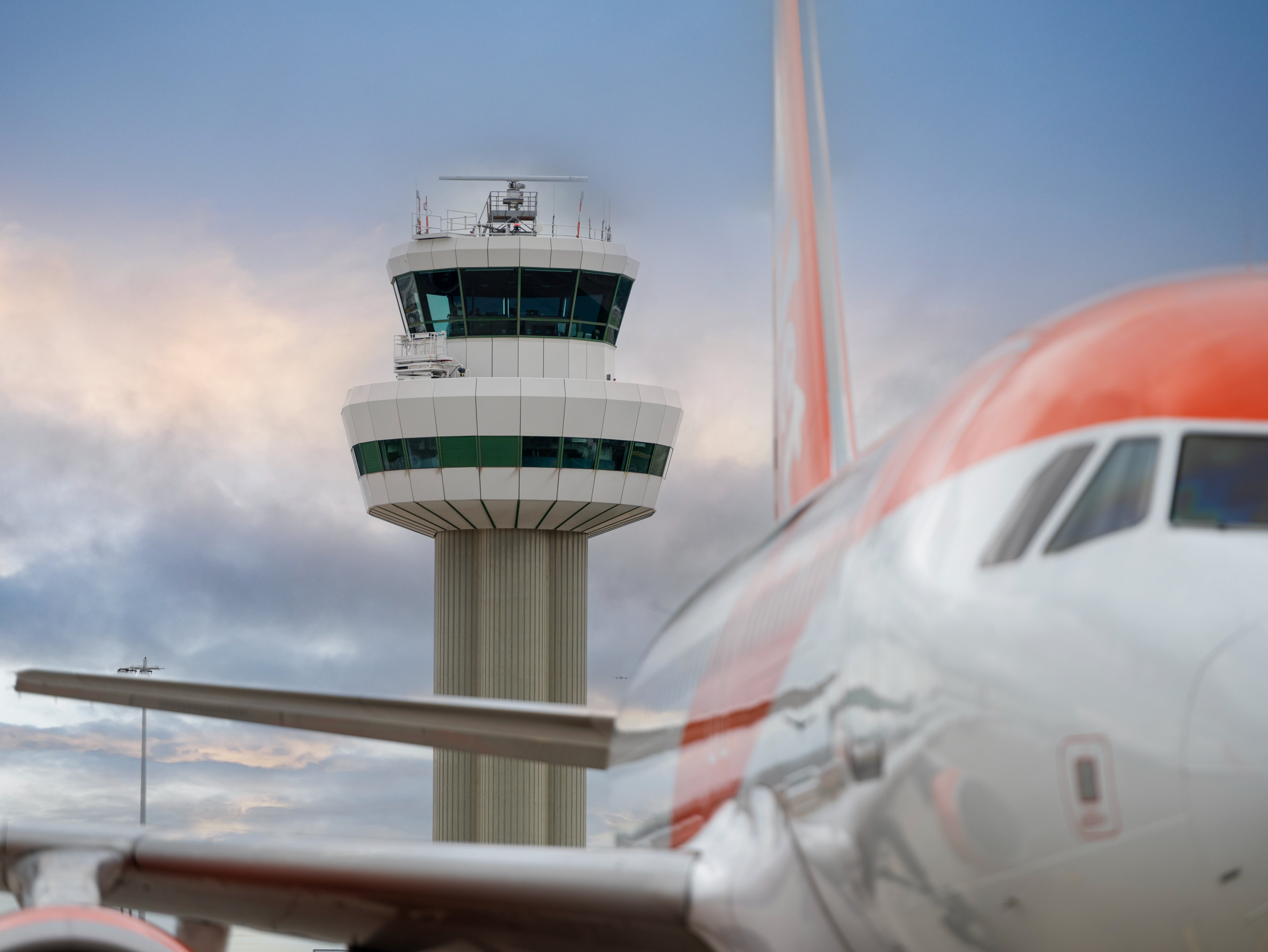 Power tower: easyJet Airbus passes Gatwick airport control tower