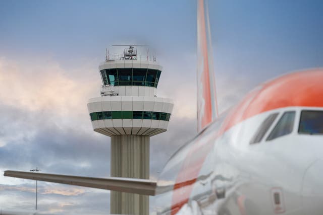 <p>In control? An easyJet Airbus passes Gatwick airport control tower</p>