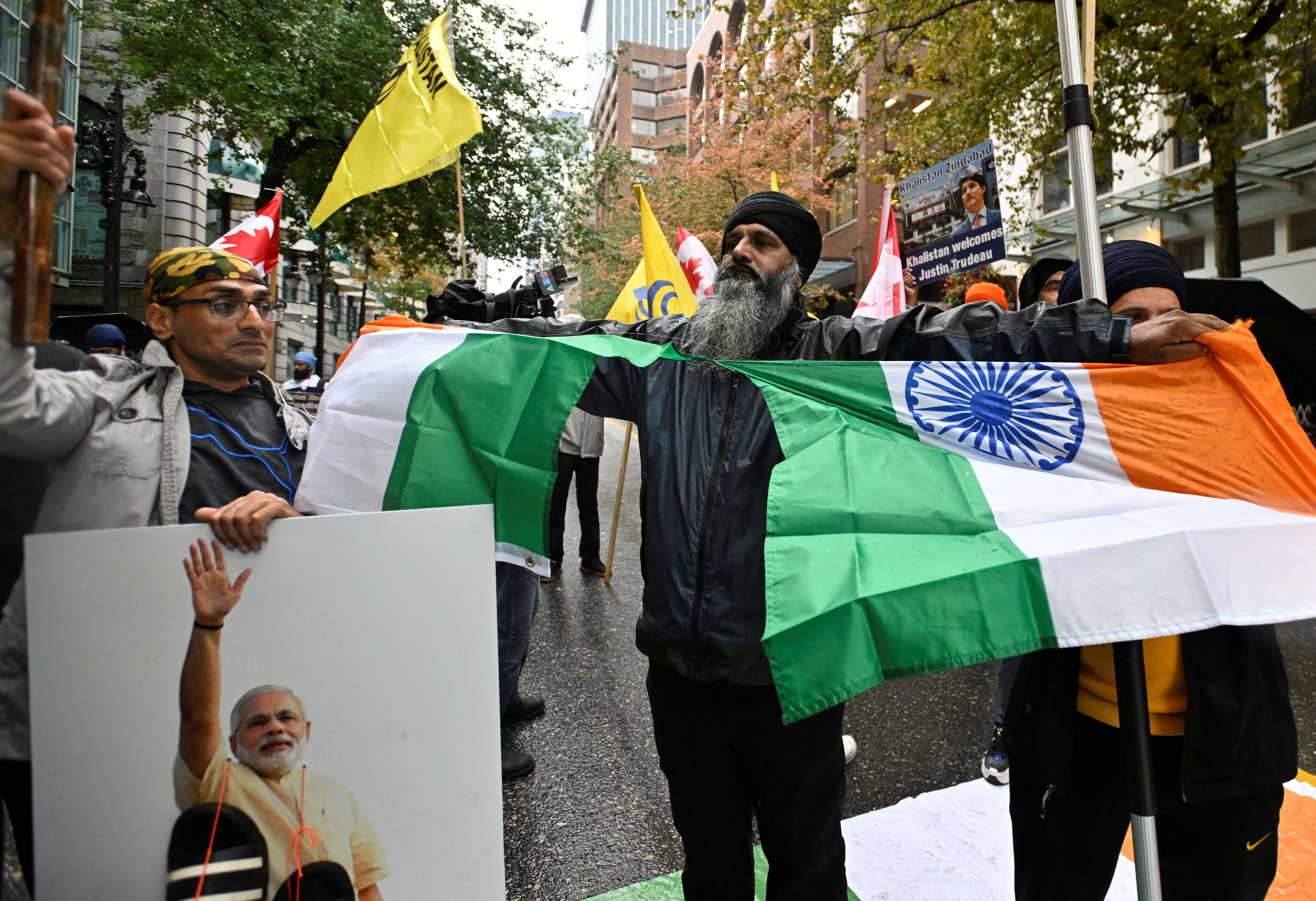 The Indian flag is torn during a protest in Vancouver, British Columbia, Canada