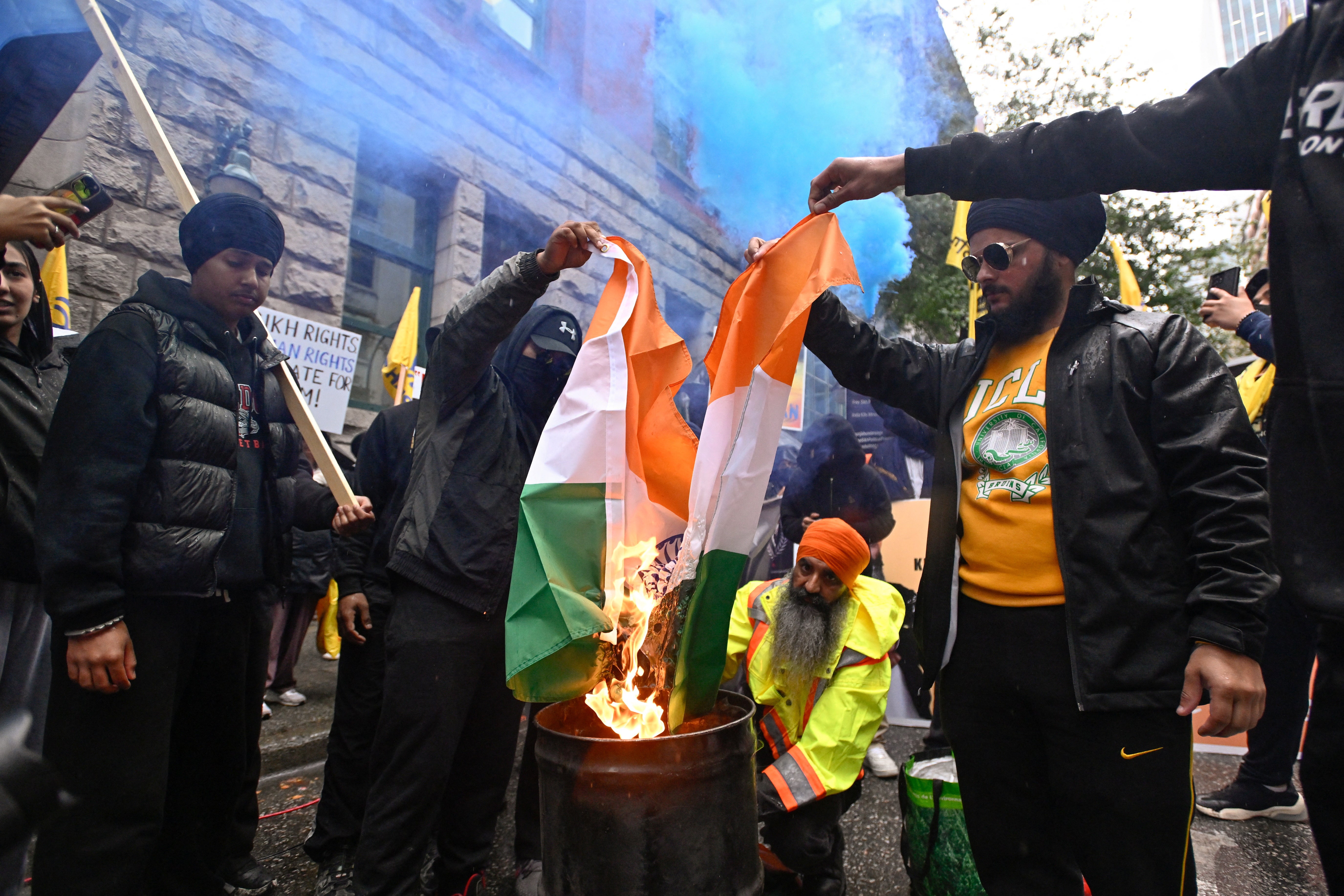An Indian flag is burned during a protest outside India’s consulate in Canada