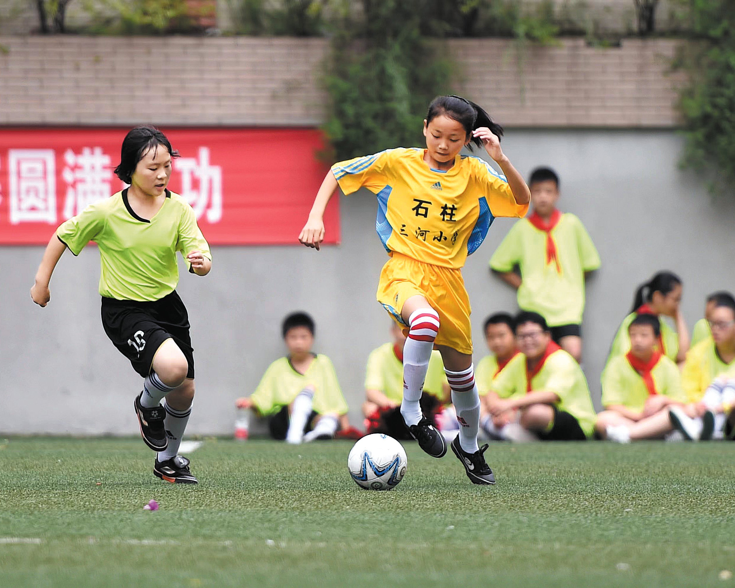 Members of Sanhe Primary School’s girls’ football team in Chongqing’s Shizhu Tujia autonomous county play in an exhibition game