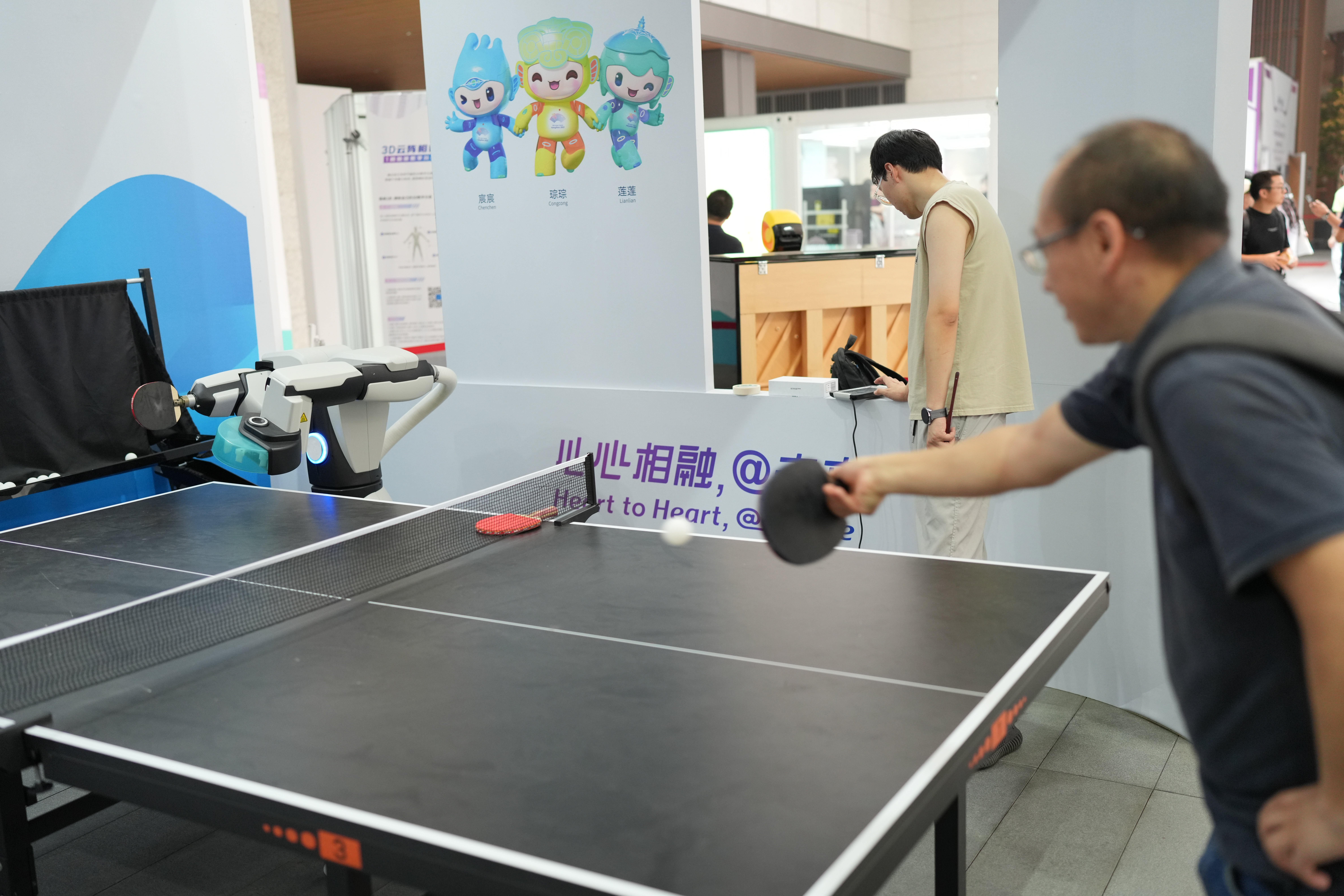 Playing table tennis with a robot is demonstrated in the Asian Games Village