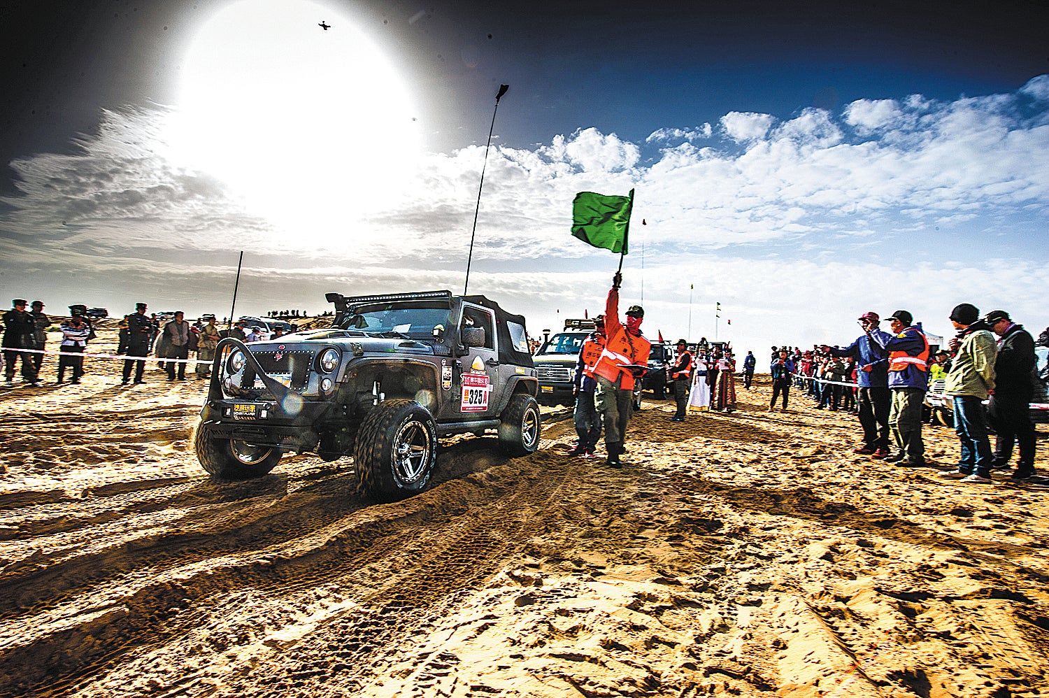 Drivers prepare for a race held in a desert in Alshaa