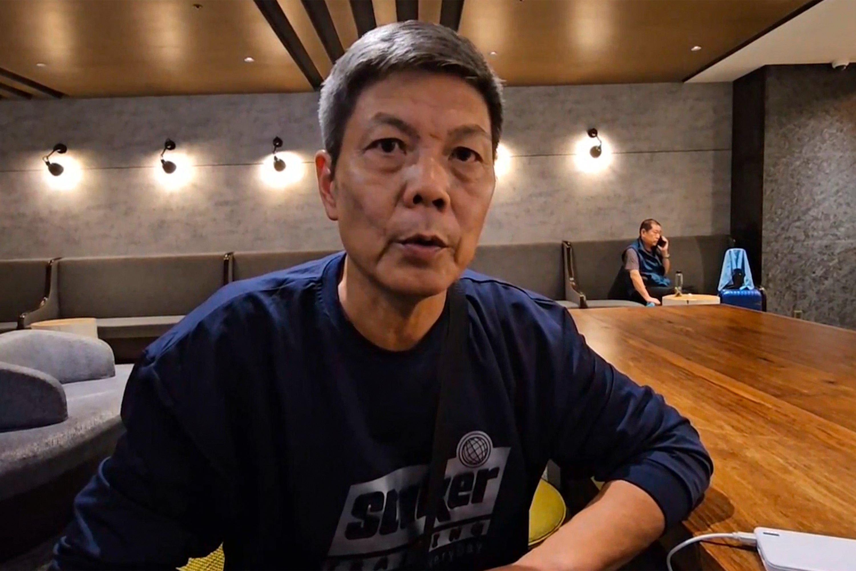 In this image taken from video footage run by TVBS, Chinese dissident Chen Siming speaks during an interview at Taoyuan International Airport’s transit lounge in Taipei on Friday