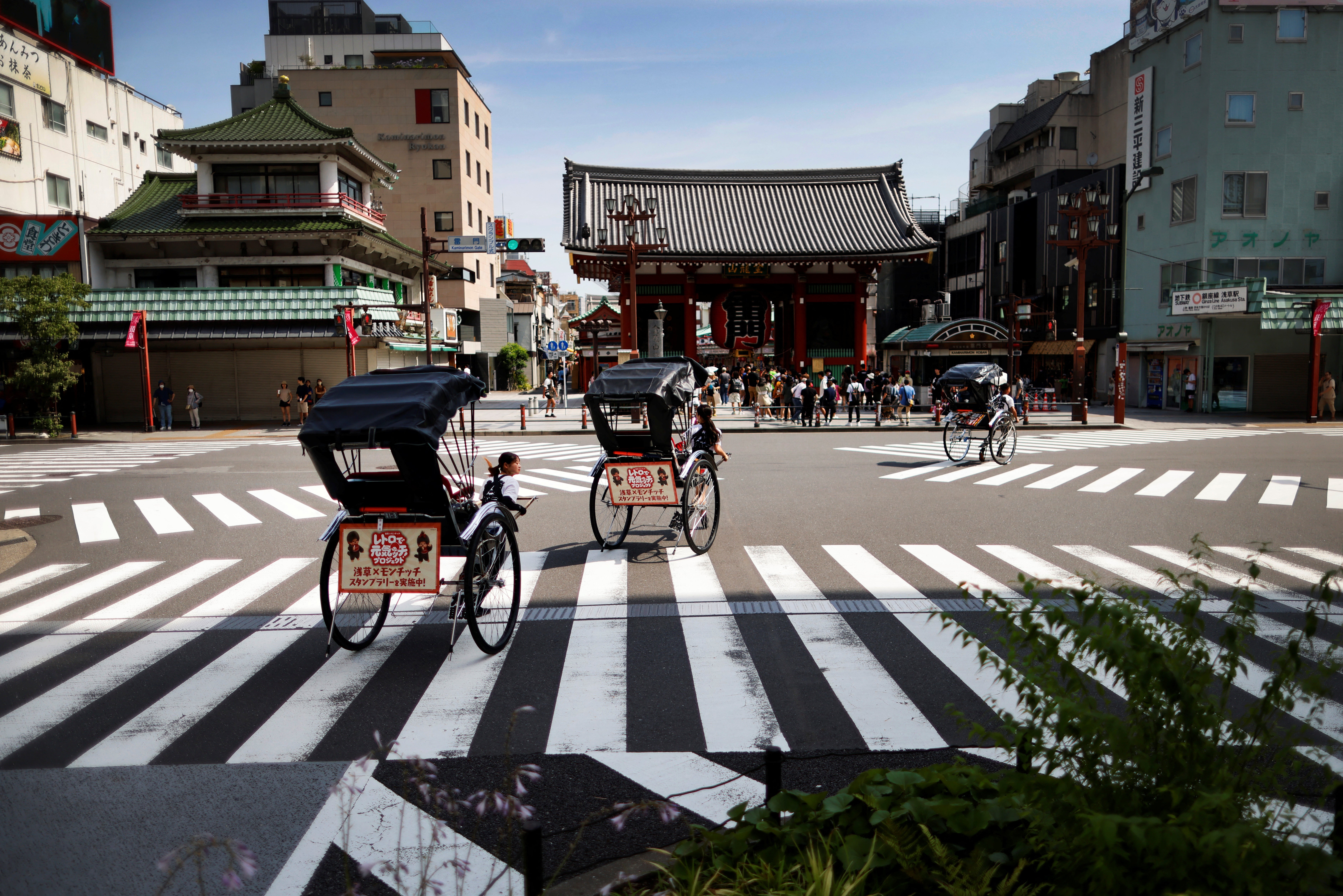 Rickshaws travel past the Kaminarimon (Thunder Gate) in Asakusa
