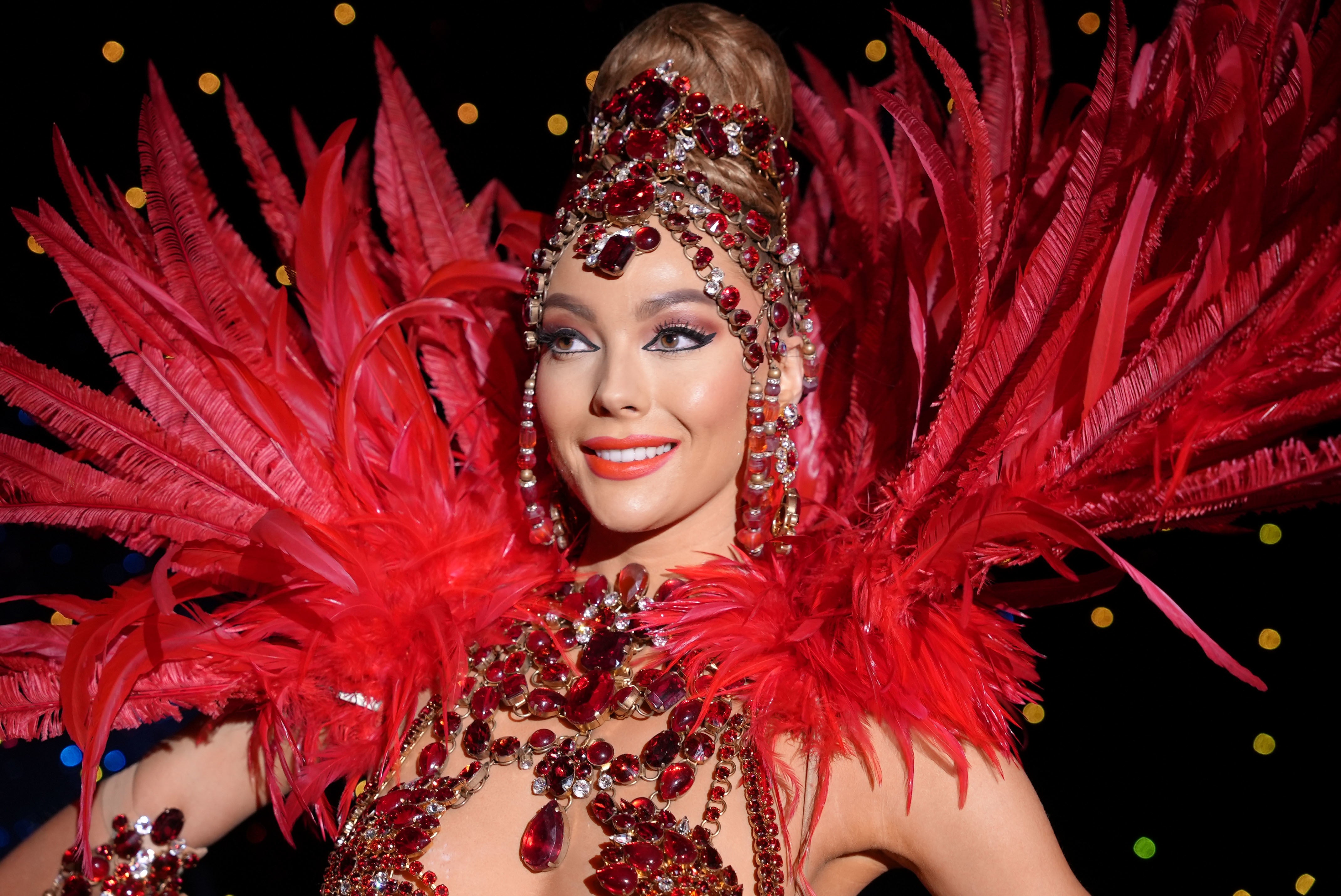 Dancer ‘Tooney’ in a red feather costume at the Moulin Rouge