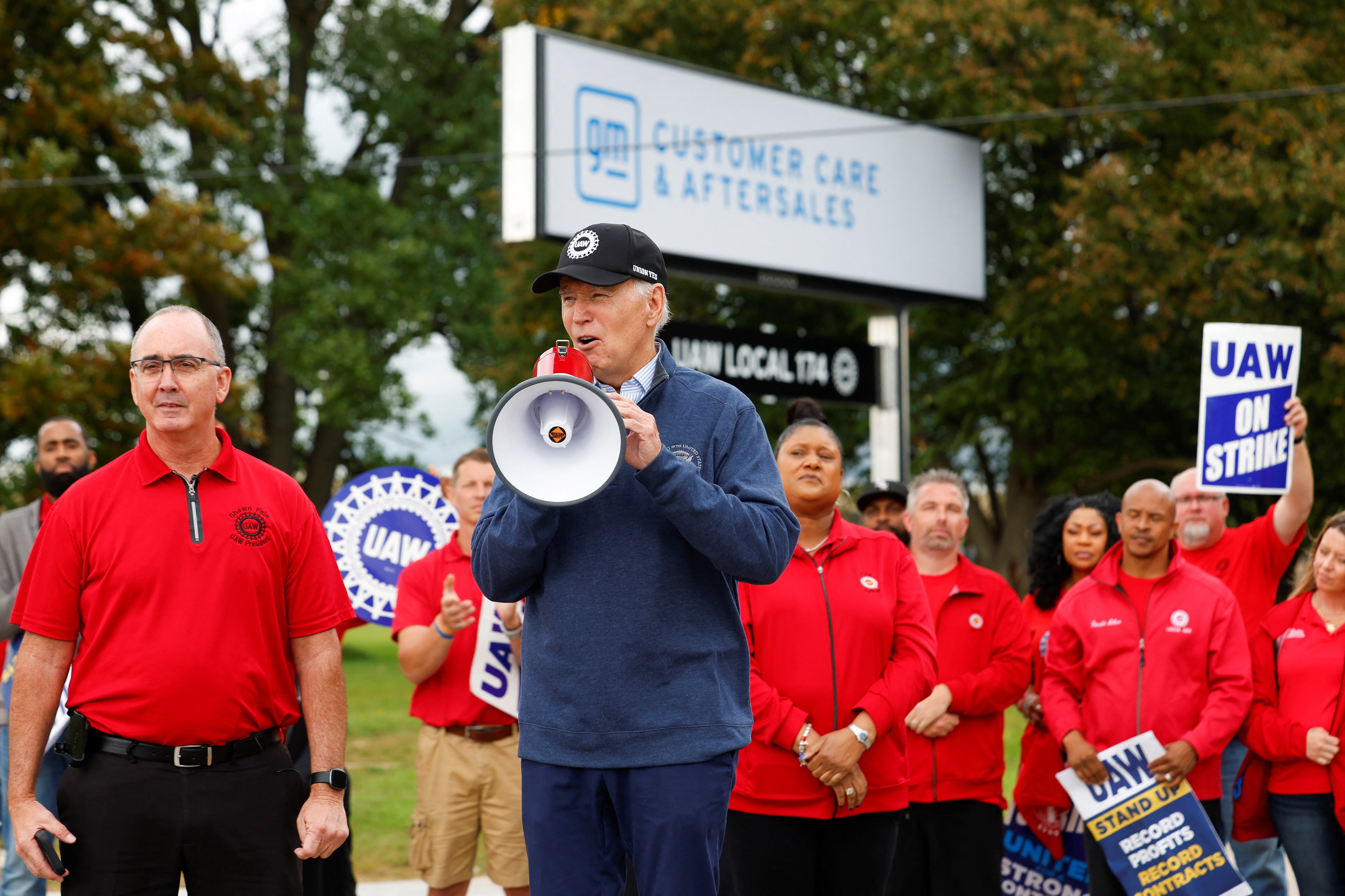<p>U.S. President Joe Biden speaks next to Shawn Fain, President of the United Auto Workers (UAW), as he joins striking members of the United Auto Workers (UAW) on the picket line outside the GM's Willow Run Distribution Center, in Bellville, Wayne County, Michigan, U.S., September 26, 2023</p>