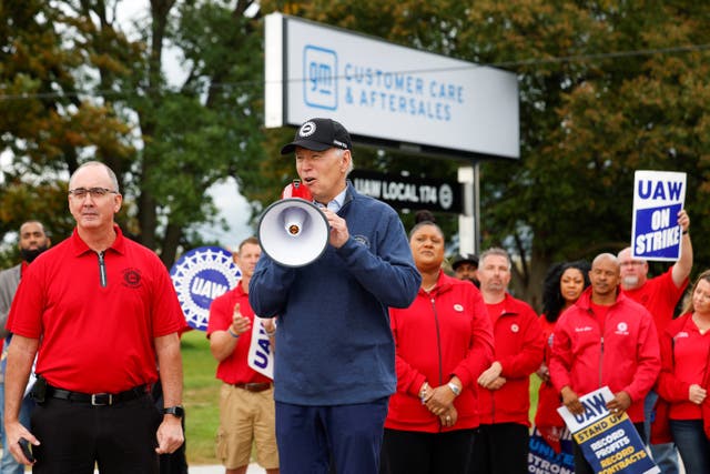 <p>U.S. President Joe Biden speaks next to Shawn Fain, President of the United Auto Workers (UAW), as he joins striking members of the United Auto Workers (UAW) on the picket line outside the GM's Willow Run Distribution Center, in Bellville, Wayne County, Michigan, U.S., September 26, 2023</p>