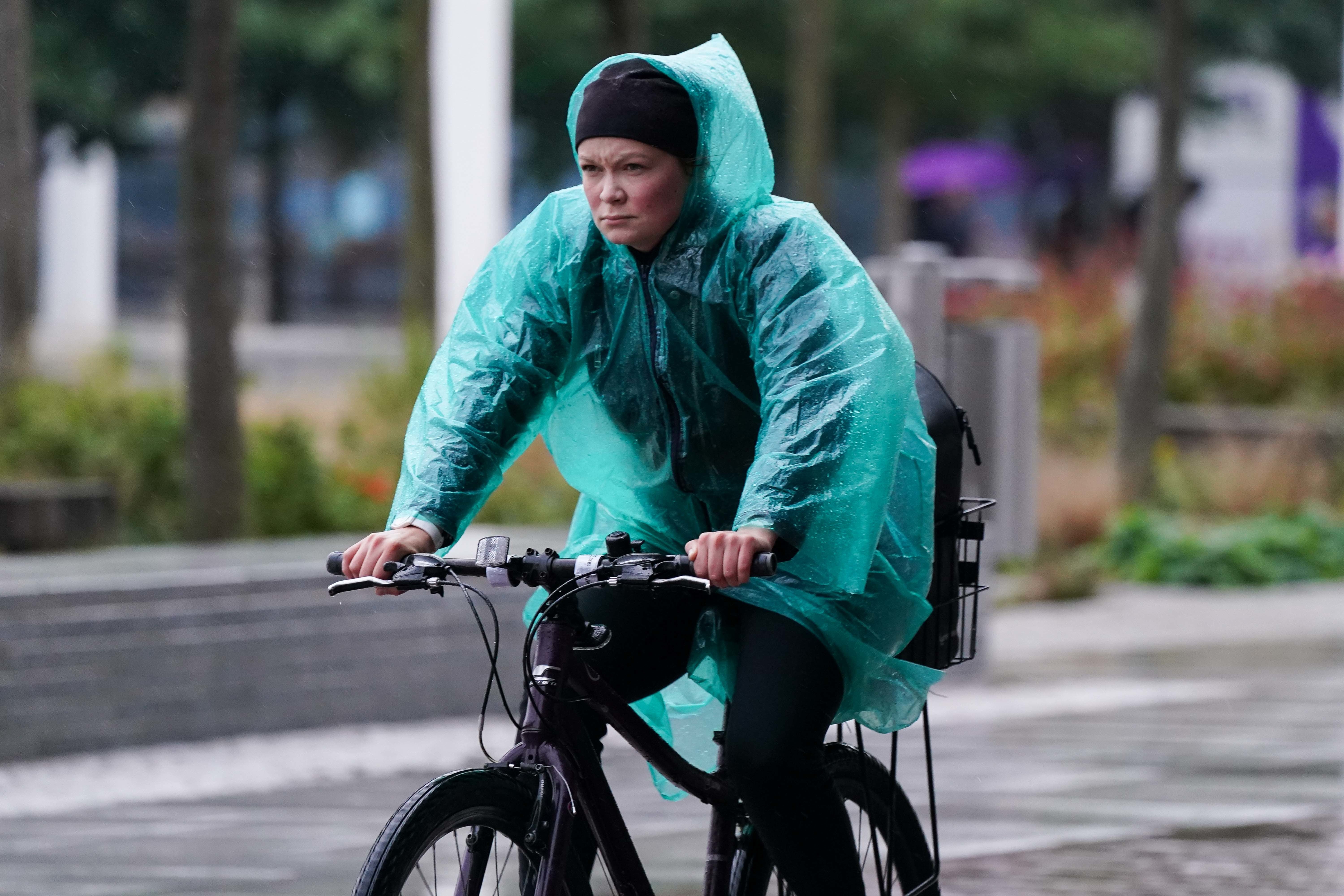 A cyclist travels through Centenary Square in Birmingham during a rainy morning