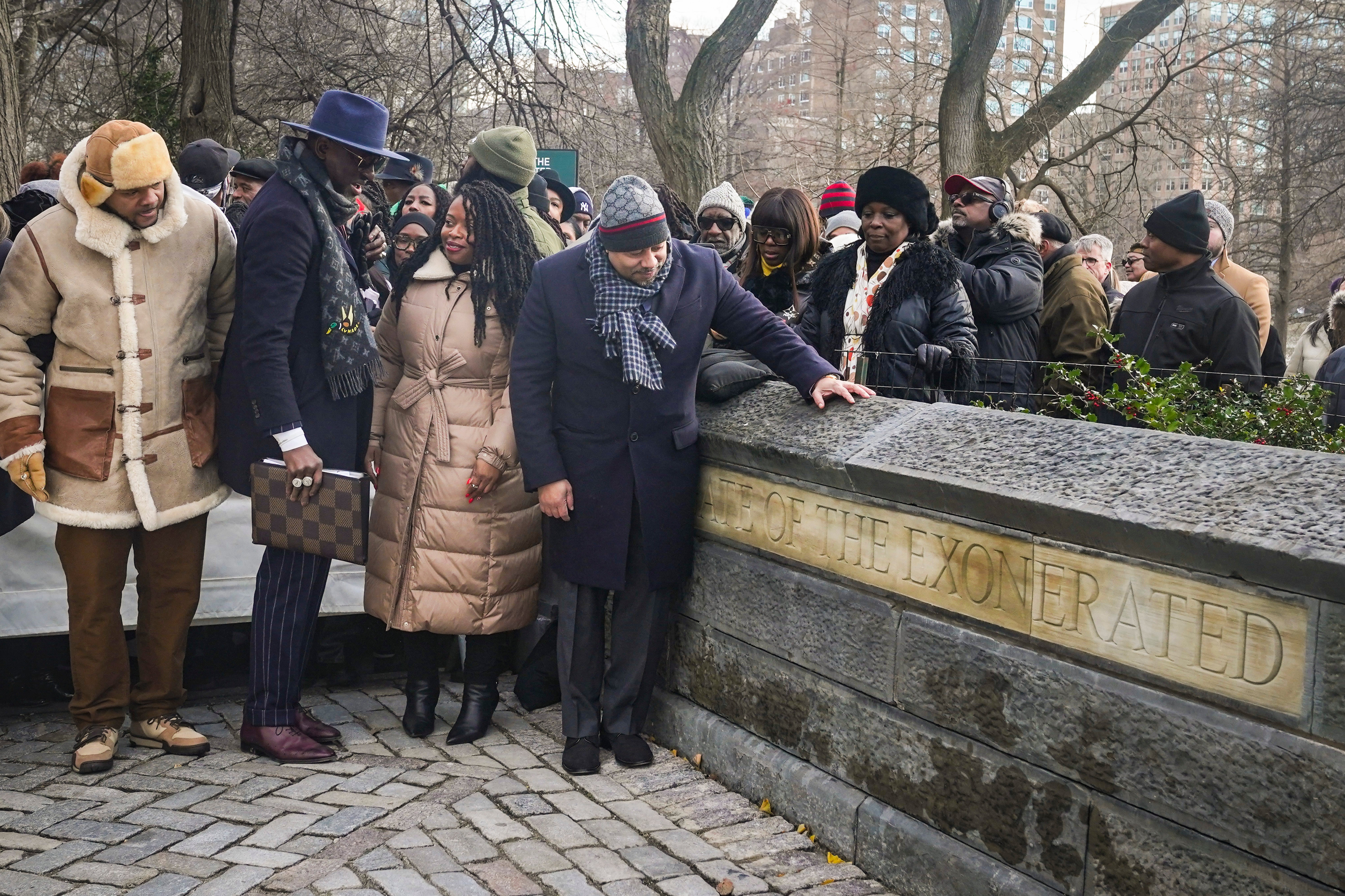 Kevin Richardson, far left, Yusef Salaam, second left, and Raymond Santana, far right in foreground, unveil the ‘The Gate of the Exonerated’ in Central Park in 2022