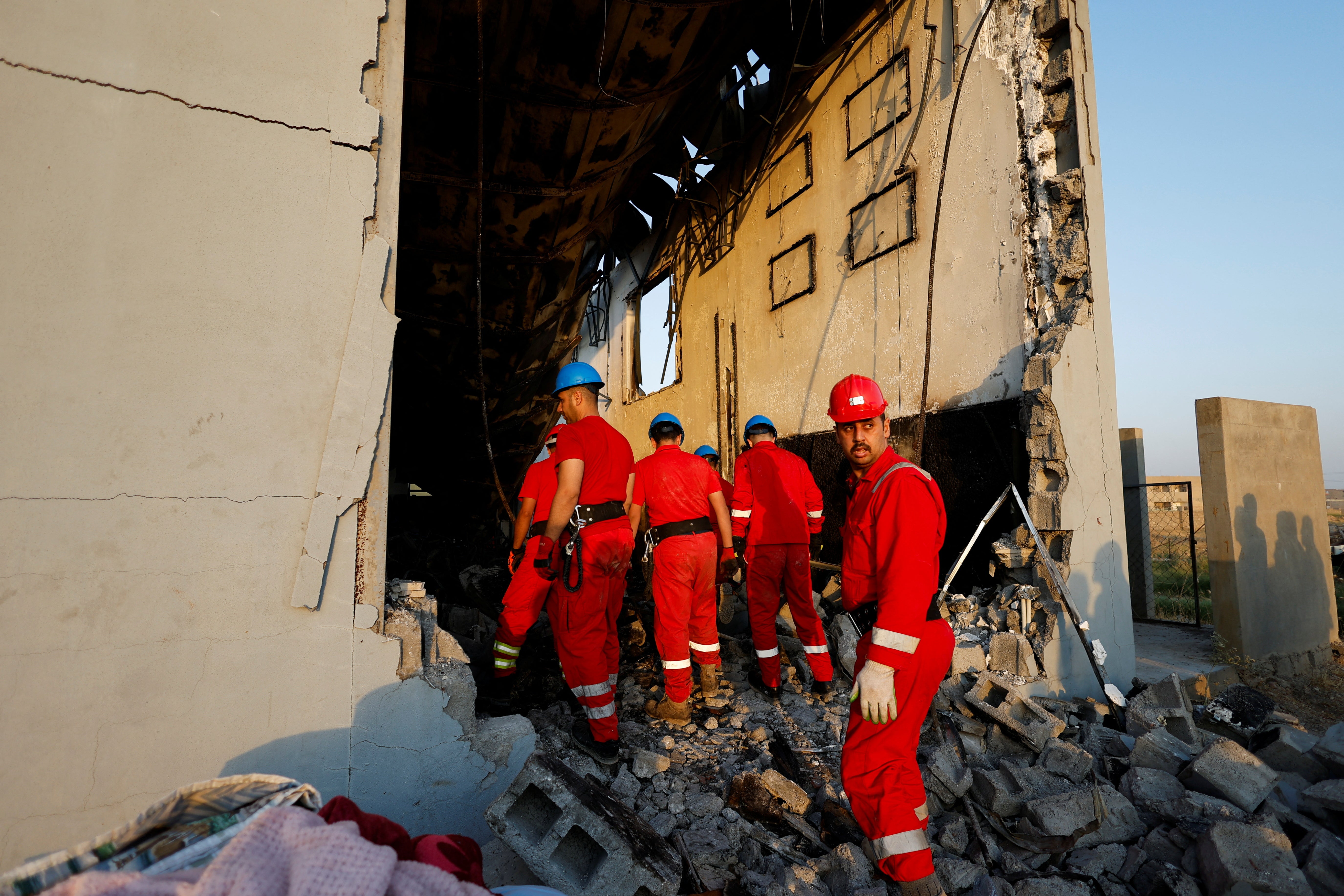 Officials work at the site following a fatal fire at a wedding celebration, in the district of Hamdaniya in Iraq’s Nineveh province, Iraq, 27 September 2023