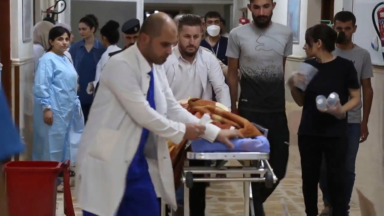 This image made from video shows medical staff taking an injured person inside a hospital in Hamdaniya, Nineveh province, Iraq, Wednesday, 27 September 2023