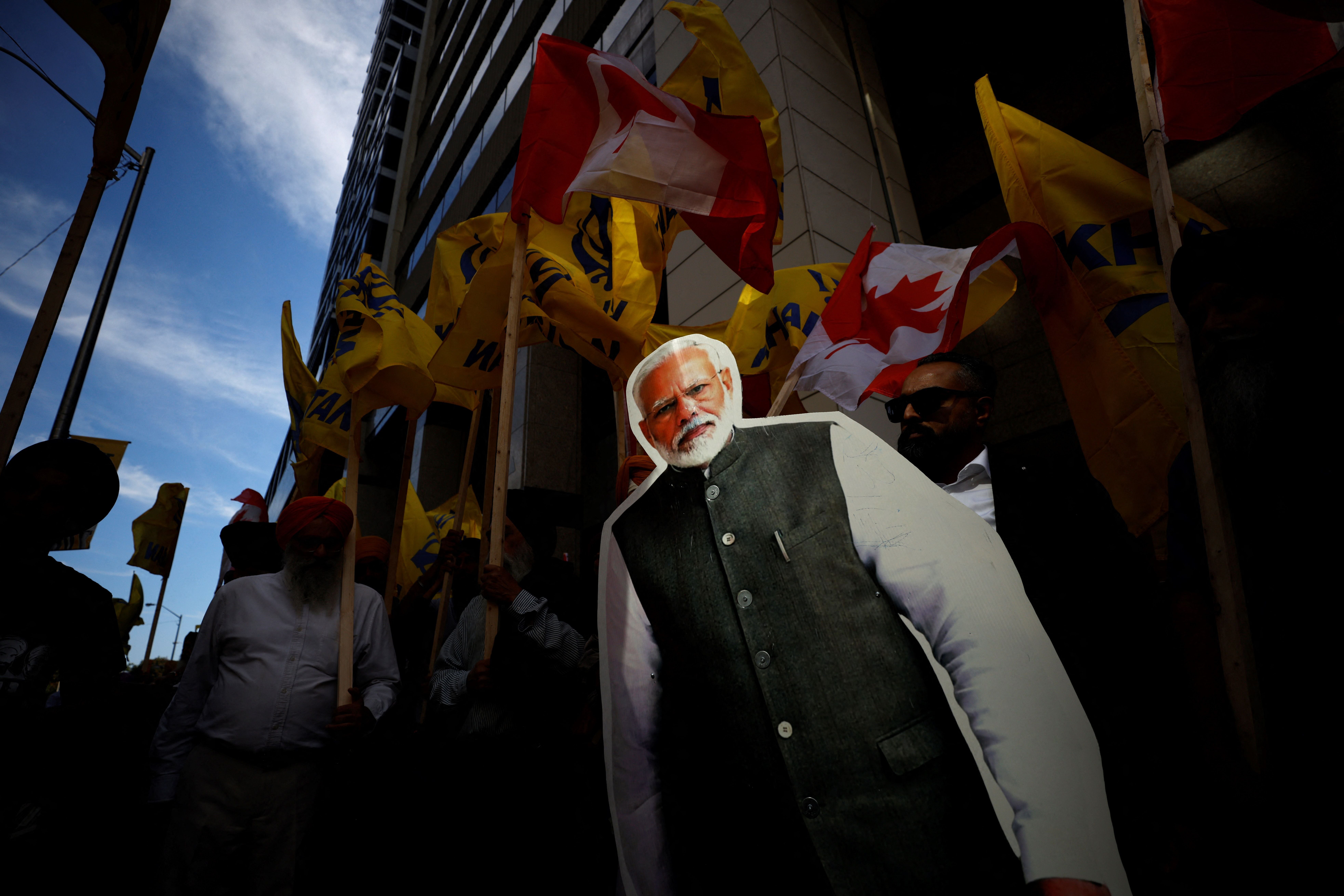 People hold a cutout depicting Indian prime minister Narendra Modi during a Sikh rally outside the Indian consulate a in Toronto