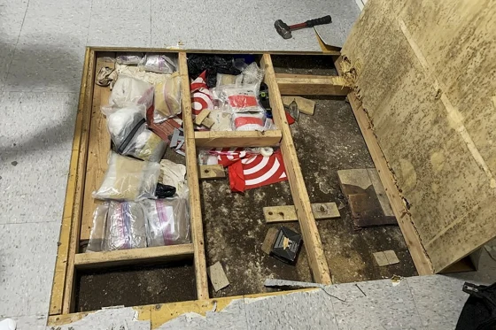 Police found large amounts of drugs and paraphernalia underneath a trap door in the daycare