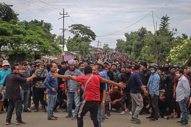 Protesters gather during rally along a street in Phougakchao Ikhai bazaar of the Bishnupur district, some 52km from Imphal on 6 September 2023