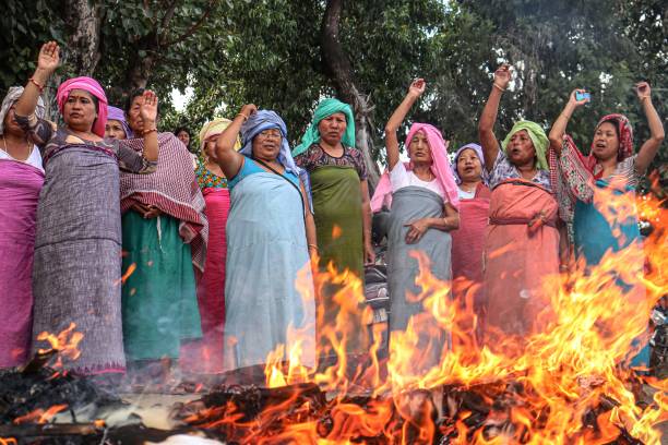 Protesters shout slogans as they burn effigies of prime minister Narendra Modi, federal home minister Amit Shah and Manipur chief minister N Biren Singh during a demonstration in Imphal on 8 September 2023