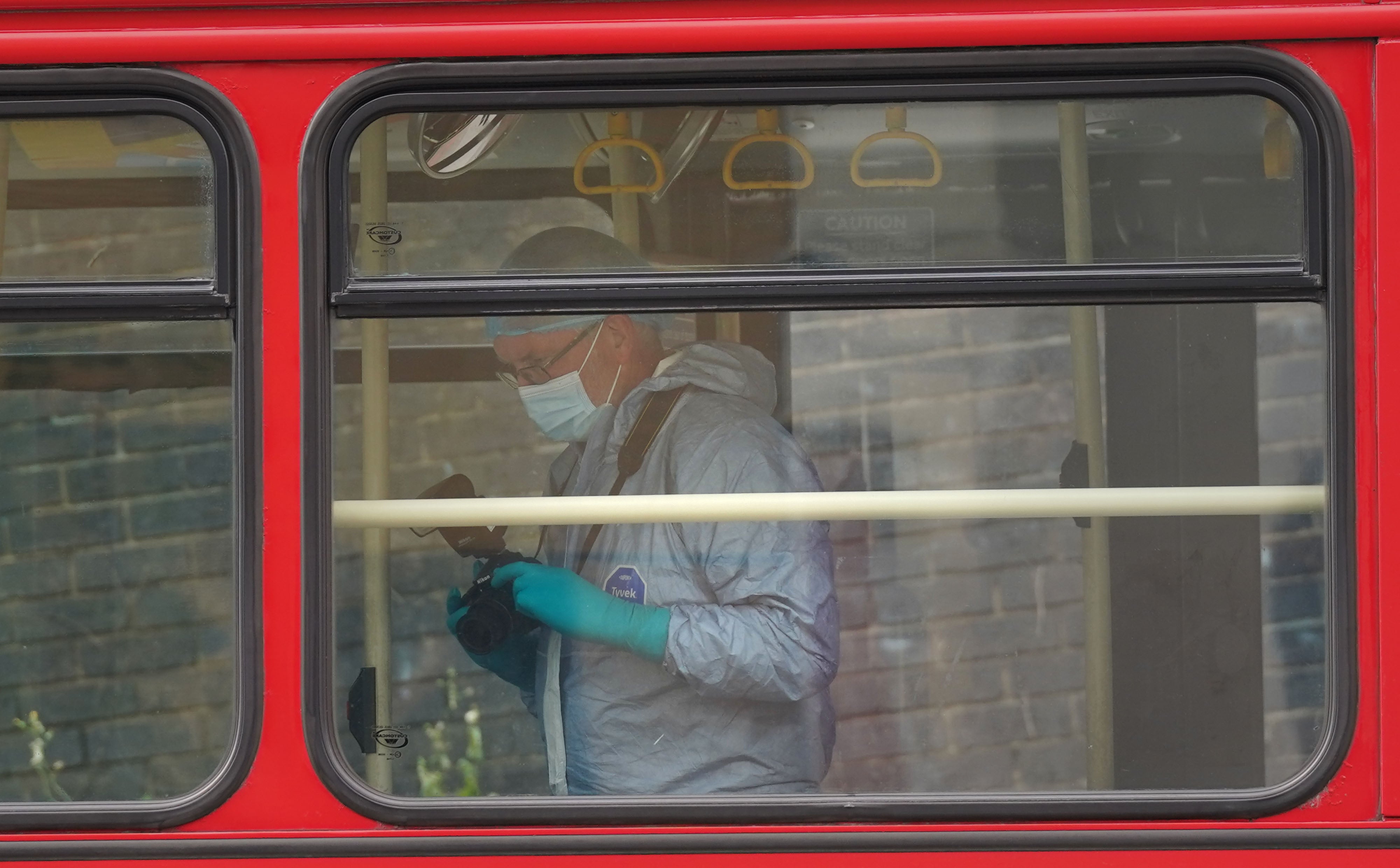 Forensic investigators examining a bus after a 15-year-old girl was stabbed to death