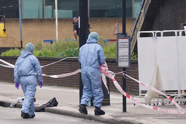 Police and forensic investigators at the scene near the Whitgift shopping centre in Croydon, south London, after a 15-year-old girl was stabbed to death (Lucy North/PA)