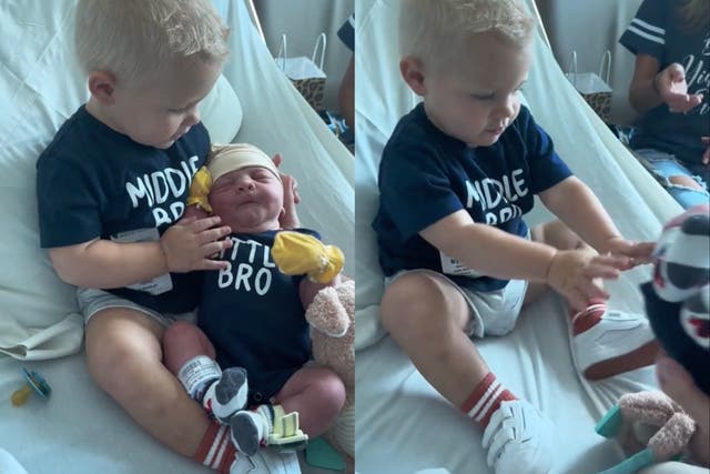 <p>Toddler realises he’s the middle child when meeting baby brother</p>