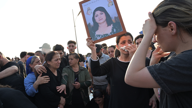 <p>Families pray for the victims of a fire at a wedding in Iraq.</p>